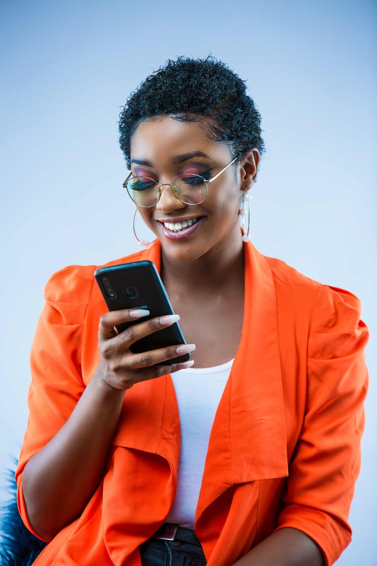 A Woman in Orange Blazer Holding a Smartphone